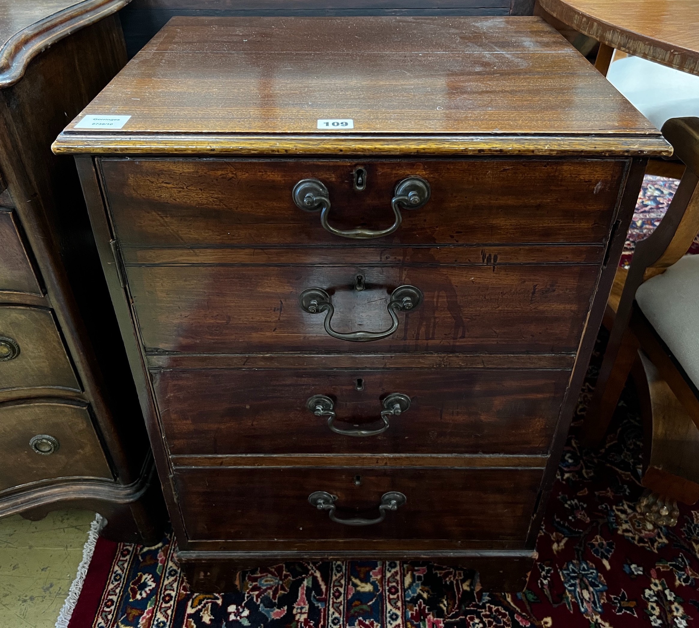 A George III and later mahogany side cabinet with dummy drawer front, incorporates old timber, width 53cm, depth 43cm, height 72cm, and a George III mahogany toilet mirror